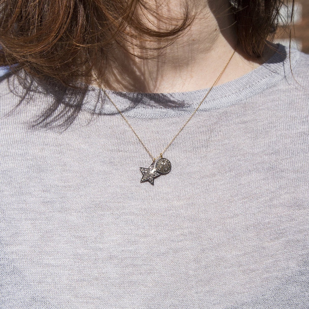 the star paired with the disc from the same collection seen on a model on 18 inch chain