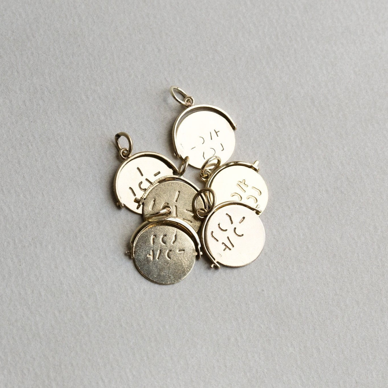 these vintage pendants although very similar, will vary slightly in form or lettering