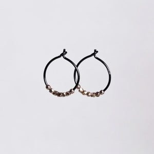 subtle rose gold nugget beads light up the blackened silver hoops