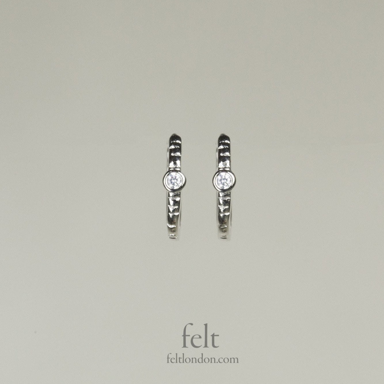 Single stone sleepers in sterling silver with a single cubic zirconia 