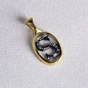 the initial pendants are made of gold, oxidised silver and diamonds 