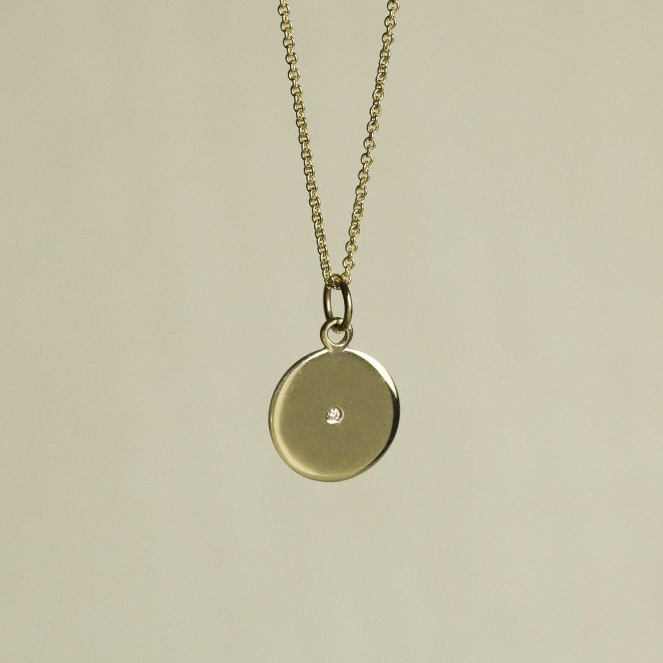 felt's own design - incredibly simple and enchanting polished gold disc with diamond on 9 carat gold chain